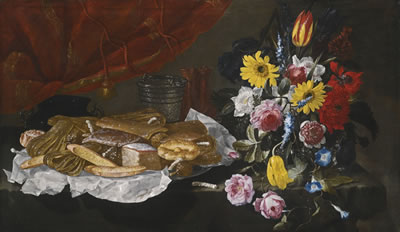 STILL LIFE WITH ROSES, CARNATIONS, TULIPS AND OTHER FLOWERS IN A GLASS VASE, WITH PASTRIES AND SWEETMEATS ON A PEWTER PLATTER, ON A STONE LEDGE IN FRONT OF A RED CURTAIN