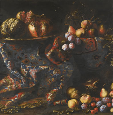 STILL LIFE OF POMEGRANATES, PEACHES, APPLES AND OTHER FRUIT DISPLAYED ON A DRAPED CARPET