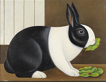 A Dutch rabbit eating lettuce