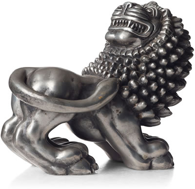 A pewter sculpture of a lion