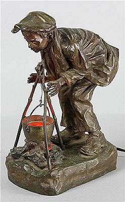 Figure of a boy leaning over a cooking pot