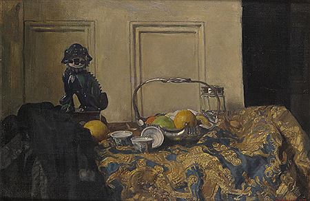 Still life of fruit in a silver fruit basket, porcelain and a pottery dog on an ornate cloth
